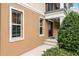 Townhome entryway with a dark brown door and manicured shrubs at 1267 Marley Ln, Winter Springs, FL 32708