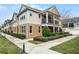 Tan townhome community with a sidewalk and manicured landscaping at 1267 Marley Ln, Winter Springs, FL 32708