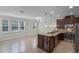 Modern kitchen with dark wood cabinetry, stainless steel appliances, and granite countertops at 1267 Marley Ln, Winter Springs, FL 32708