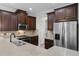 Modern kitchen with dark wood cabinets, granite counters, and stainless steel appliances at 1267 Marley Ln, Winter Springs, FL 32708