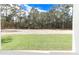 Landscaped backyard with grassy area and natural wooded backdrop at 12707 Sw 78Th Pl, Dunnellon, FL 34432