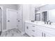 Double vanity bathroom with white cabinets and quartz countertops at 12707 Sw 78Th Pl, Dunnellon, FL 34432