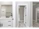 Clean bathroom with white vanity, and a view into another room at 12707 Sw 78Th Pl, Dunnellon, FL 34432