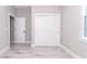 Simple bedroom with white door and closet, light gray walls, and tile floor at 12707 Sw 78Th Pl, Dunnellon, FL 34432