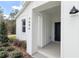 Front entrance with black door and white columns at 12707 Sw 78Th Pl, Dunnellon, FL 34432