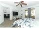 Bright bedroom featuring a floral bedspread, a flat-screen TV, and access to a screened in porch at 1369 Black Willow Trl, Altamonte Springs, FL 32714