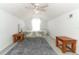 Cozy bedroom features a ceiling fan, plush rug, and bright natural light at 1369 Black Willow Trl, Altamonte Springs, FL 32714