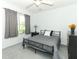 Bedroom showcasing a metal frame bed, neutral bedding, gray curtains, and a view to the greenery outside at 1369 Black Willow Trl, Altamonte Springs, FL 32714