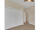 Bedroom with double door closet and wood-look flooring at 14 Fisher Loop Pass, Ocklawaha, FL 32179