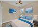 Virtually staged bedroom with light blue bedding and ocean-themed artwork at 14 Fisher Loop Pass, Ocklawaha, FL 32179