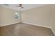 Bright bedroom with wood-look flooring and a large window at 14 Fisher Loop Pass, Ocklawaha, FL 32179