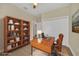 Virtually staged home office features built-in shelving and a large desk at 14 Fisher Loop Pass, Ocklawaha, FL 32179