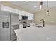 Modern kitchen with white cabinets, stainless steel appliances, and a quartz countertop at 14 Fisher Loop Pass, Ocklawaha, FL 32179