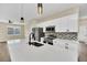 Modern kitchen featuring white cabinets, quartz countertops, and stainless steel appliances at 14 Fisher Loop Pass, Ocklawaha, FL 32179