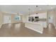 Modern kitchen with island, stainless steel appliances, and white cabinets at 14 Fisher Loop Pass, Ocklawaha, FL 32179