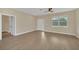 Bright living room features wood-look floors and neutral walls at 14 Fisher Loop Pass, Ocklawaha, FL 32179