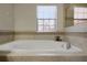 Bathroom with soaking tub and window at 1498 Moon Valley Dr, Davenport, FL 33896