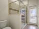 Bathroom with shower, toilet and door leading outside at 1498 Moon Valley Dr, Davenport, FL 33896