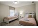 Bright bedroom with two twin beds, nightstands, and window coverings at 1498 Moon Valley Dr, Davenport, FL 33896