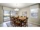 Dining room with a wooden table, chairs, and view of the pool at 1498 Moon Valley Dr, Davenport, FL 33896