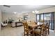 Bright dining room with wood table and access to the pool at 1498 Moon Valley Dr, Davenport, FL 33896