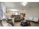 Living room with neutral colored sofas, coffee table, and view of dining area at 1498 Moon Valley Dr, Davenport, FL 33896