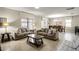 Spacious living room with two sofas, a coffee table and a view into the dining room at 1498 Moon Valley Dr, Davenport, FL 33896