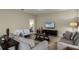 Living room with sofas, coffee table, and a large TV at 1498 Moon Valley Dr, Davenport, FL 33896