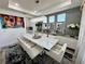 Modern dining room with white chairs and a statement art piece at 16750 Toccoa Row, Winter Garden, FL 34787