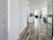 Bright hallway with wood-look flooring leading to the kitchen and living areas at 16750 Toccoa Row, Winter Garden, FL 34787