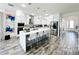 Modern kitchen featuring white cabinets, a large island, and stainless steel appliances at 16750 Toccoa Row, Winter Garden, FL 34787