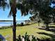 Scenic view of a lake with lush landscaping and a dock at 16750 Toccoa Row, Winter Garden, FL 34787