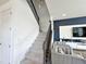 Modern staircase with wrought iron railing and textured wall at 16750 Toccoa Row, Winter Garden, FL 34787