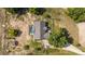 Overhead aerial view of a house with a pool and mature trees, blending comfort with natural beauty at 17901 Coralwood Ln, Groveland, FL 34736