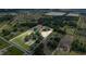 Aerial view of the property highlighting the home's location, the extensive land, and surrounding natural beauty at 17901 Coralwood Ln, Groveland, FL 34736