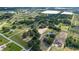 Gorgeous aerial view of the property featuring lush landscaping, mature trees, and ample open space at 17901 Coralwood Ln, Groveland, FL 34736