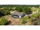 Expansive lot featuring a screened-in pool, lush trees, and long driveway leading to the home at 17901 Coralwood Ln, Groveland, FL 34736