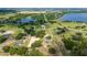 Aerial view of the property nestled amid lush greenery and serene lakes, offering a peaceful and private setting at 17901 Coralwood Ln, Groveland, FL 34736