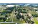 Expansive aerial view of the property showcasing lush greenery, serene ponds, and surrounding farmland at 17901 Coralwood Ln, Groveland, FL 34736