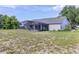 View of the back of the home with pool and spacious backyard at 17901 Coralwood Ln, Groveland, FL 34736