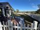 Backyard with patio, white fence, and windmill view at 17901 Coralwood Ln, Groveland, FL 34736