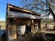 Two-stall wooden barn with metal roof and a fan at 17901 Coralwood Ln, Groveland, FL 34736