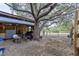 Horse barn with metal roof, and horses grazing nearby at 17901 Coralwood Ln, Groveland, FL 34736