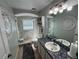 Updated bathroom with a walk-in shower, tile flooring, and modern vanity at 17901 Coralwood Ln, Groveland, FL 34736