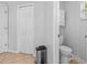 Neutral bathroom includes tile floors, toilet, and storage cabinet at 17901 Coralwood Ln, Groveland, FL 34736