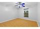 Well-lit bedroom featuring wood floors, ceiling fan and window at 17901 Coralwood Ln, Groveland, FL 34736