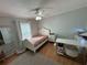 Charming bedroom with a twin bed, desk, and window at 17901 Coralwood Ln, Groveland, FL 34736