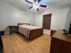 Cozy bedroom with wood floors and ceiling fan at 17901 Coralwood Ln, Groveland, FL 34736