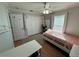 Bright bedroom with twin bed, wood floors, and closet at 17901 Coralwood Ln, Groveland, FL 34736
