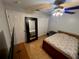Bedroom with a queen bed, ceiling fan and wood floors at 17901 Coralwood Ln, Groveland, FL 34736